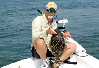 Captain Kirk Waltz Holding His Catch On His Boat